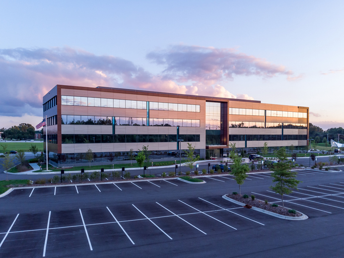Evening shot of office building exterior with large parking lot in middlesex ma