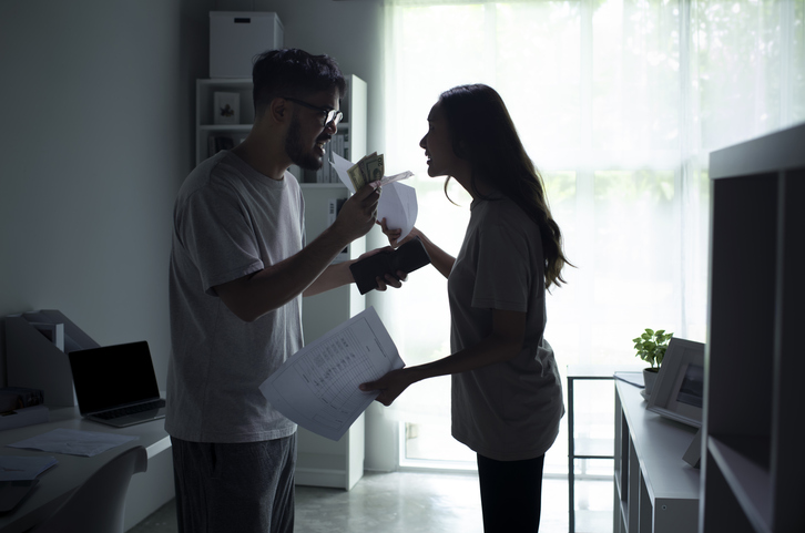 Asian couple arguing about money at home, going through a divorce