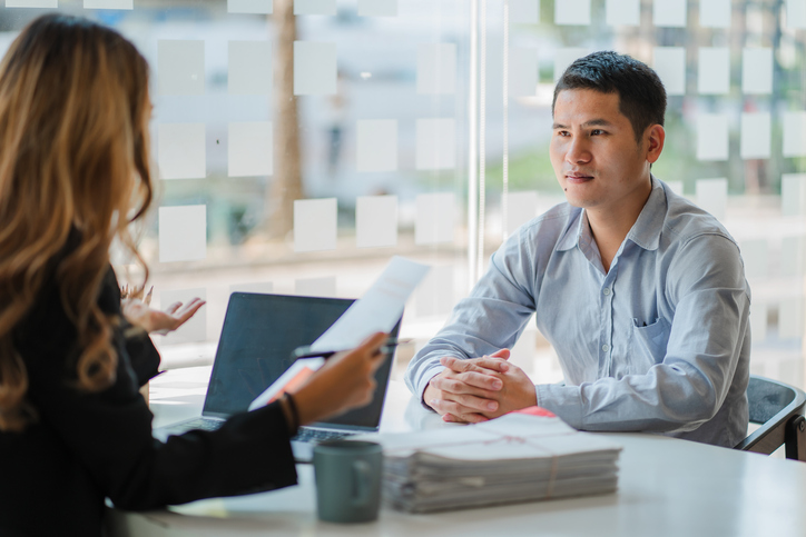 two young Asian male and female talking about real estate appraisal in middlesex ma