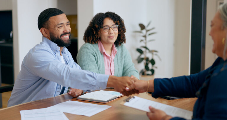 Couple, handshake and lawyer with documents for wills