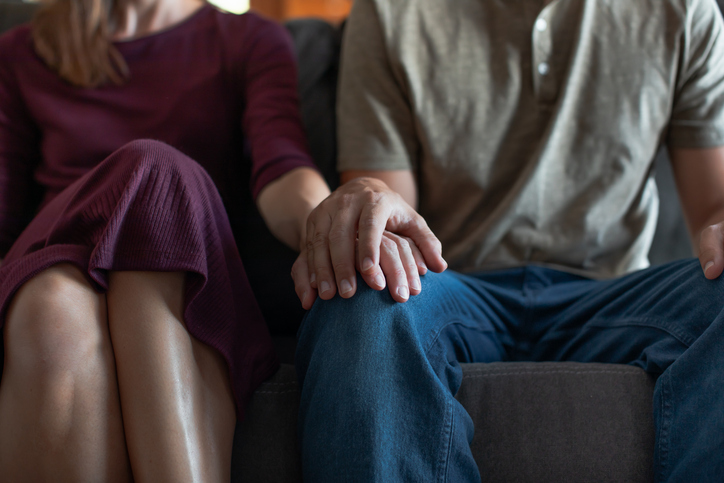 Man and woman holding hands.