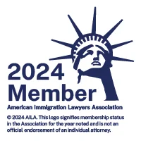 “2024 American Immigration Lawyers Association member badge with Statue of Liberty graphic.”