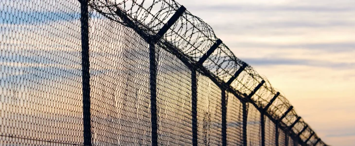 “High security fence with razor wire.”
