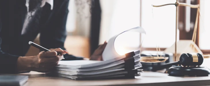 attorney looking over paperwork at his desk