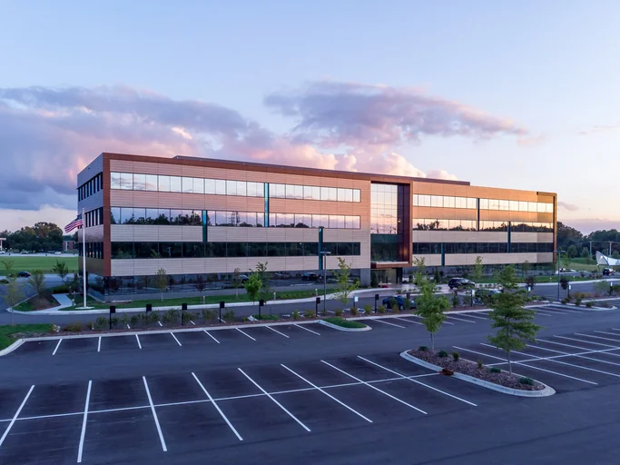 Evening shot of office building exterior with large parking lot in middlesex ma