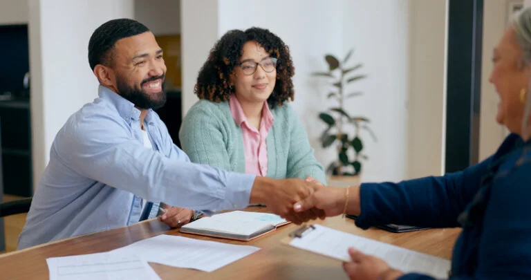 Couple, handshake and lawyer with documents for wills